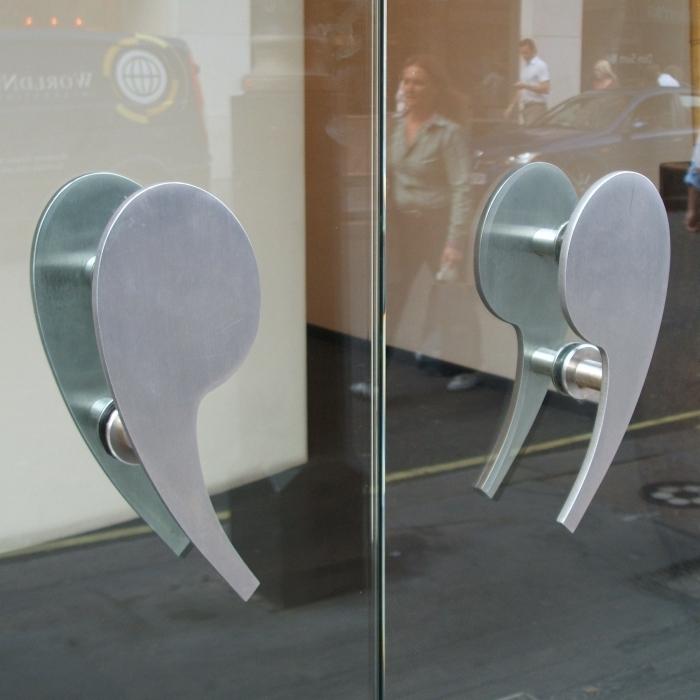Glass door with quote-marks handles