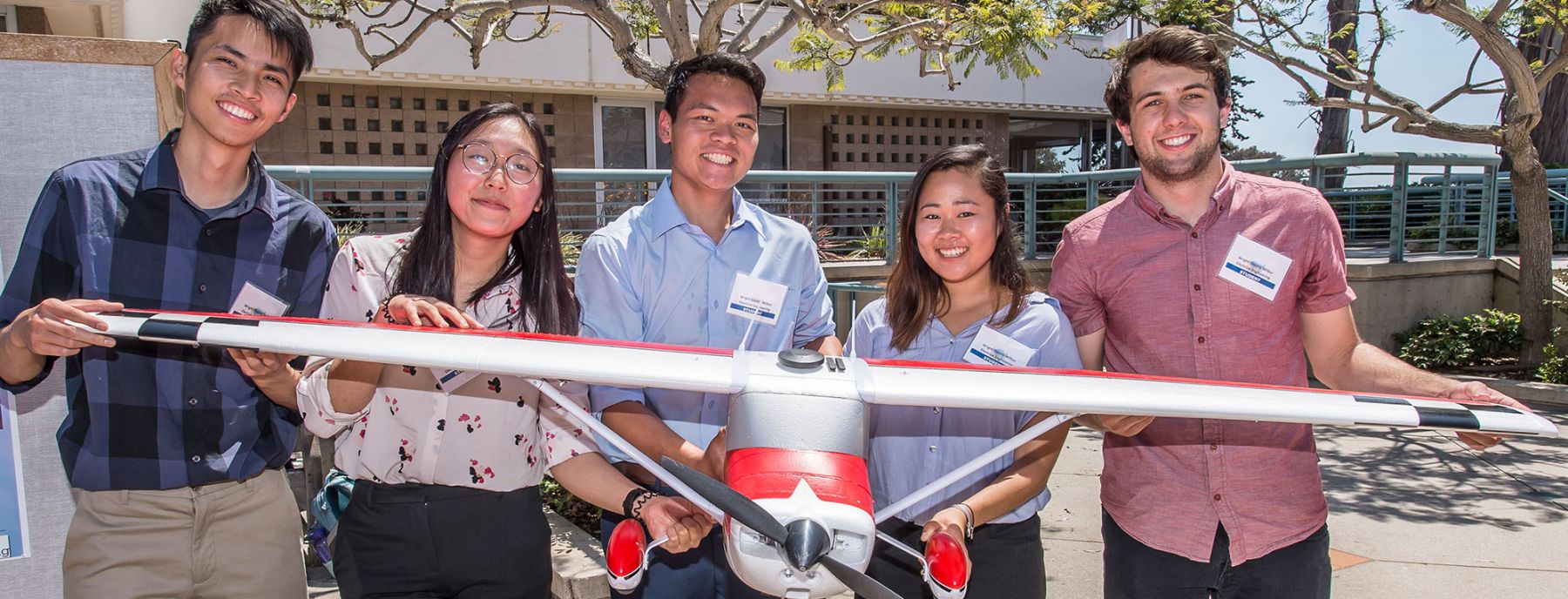 photo of students with model airplane project