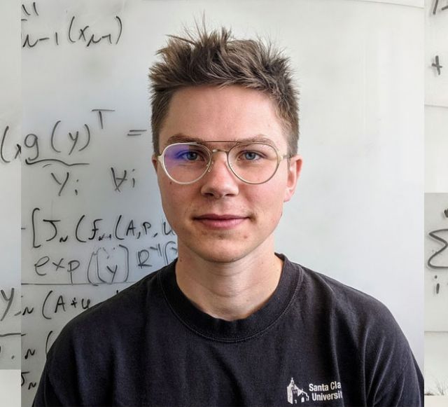 Photo of nathan in front of white board