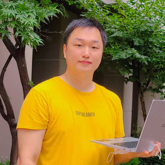 hoontaek with laptop outside of Harold Frank Hall