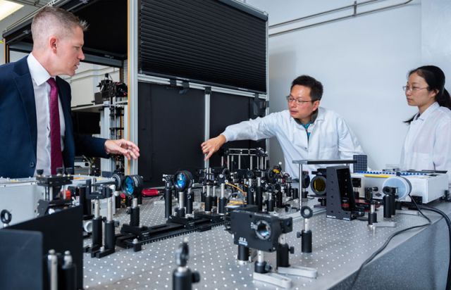 photo of smith with postdocs in the lab