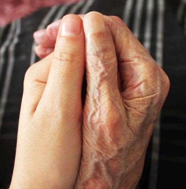 Photo of young and old hands together