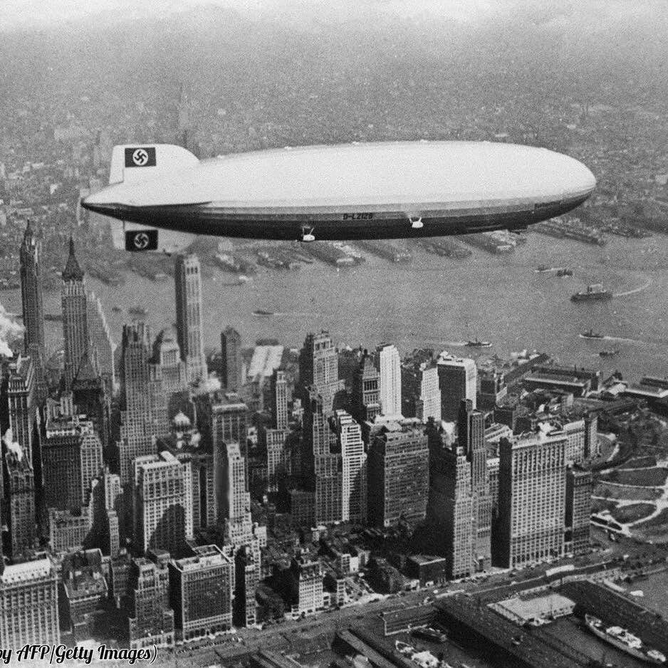 The German airship Hindenburg flies over NYC in 1937