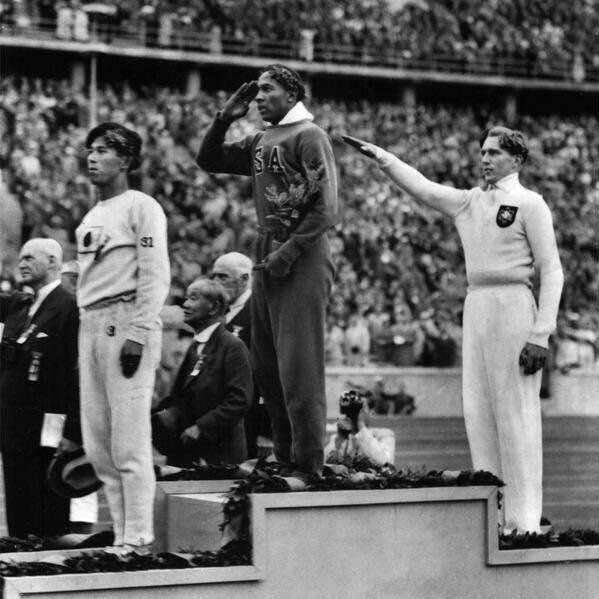 Jesse Owens winning a gold medal in Nazi Germany's 1936 Olympics