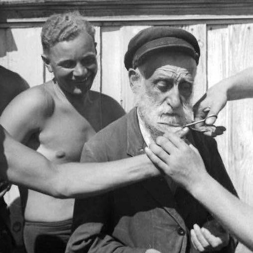 German soldiers cut off the beard of an old Jewish man