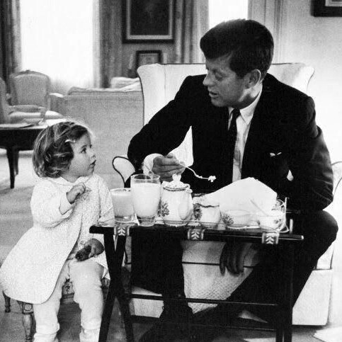 President John F. Kennedy having a tea party with his daughter Caroline