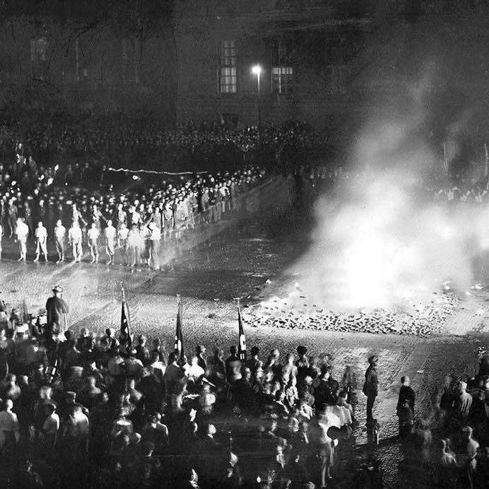 Nazi youth gather at the University of Berlin to burn piles of 'un-German' books written by Jews and left-wing authors, 1933