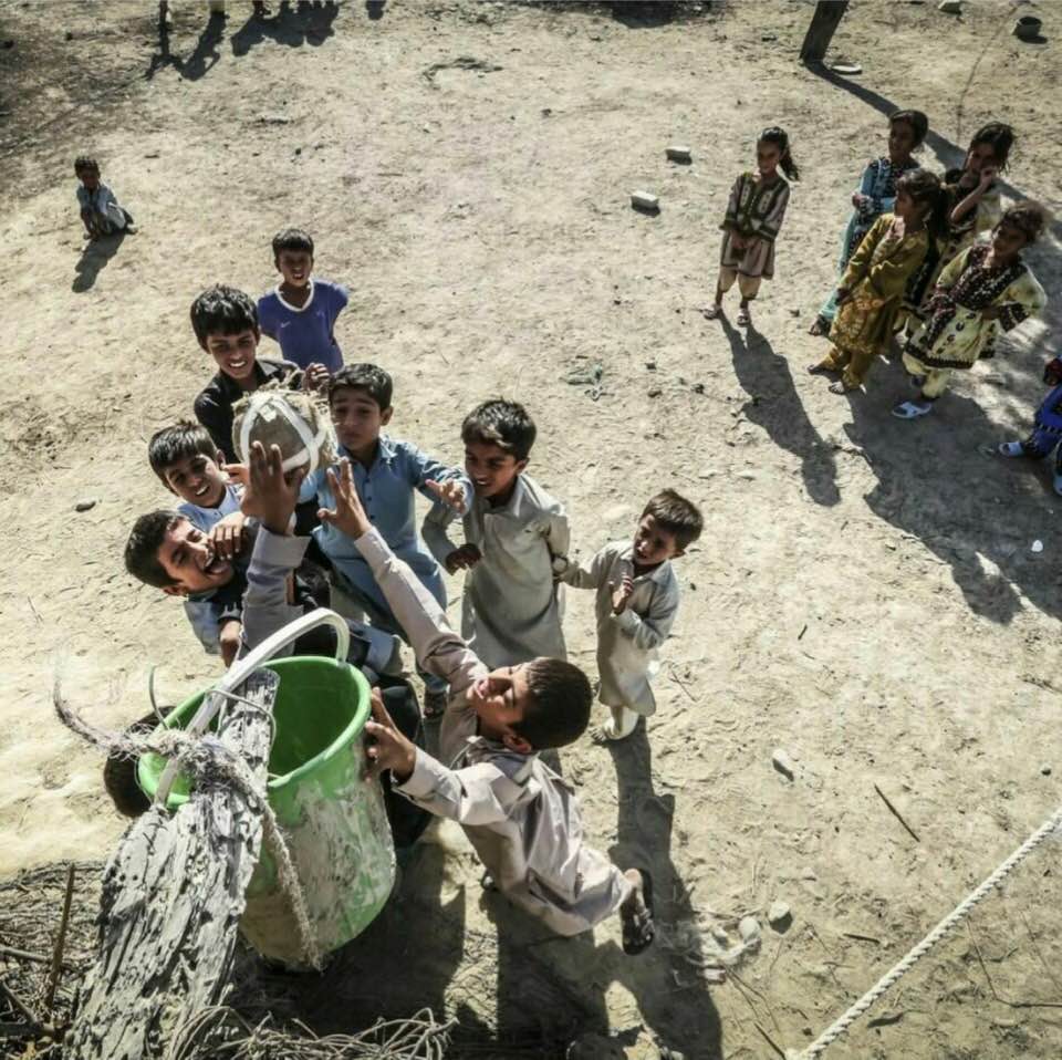 Impoverished kids in southeastern Iran playing a version of basketball