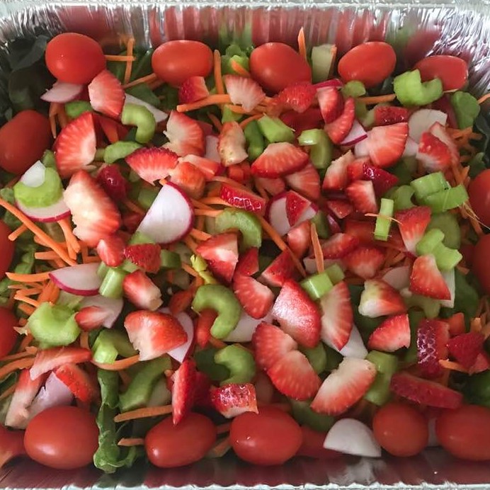 Salad, made with nine different ingredients: Lettuce, tomato, carrot, cucumber, celery, green pepper, red pepper, radish, strawberry