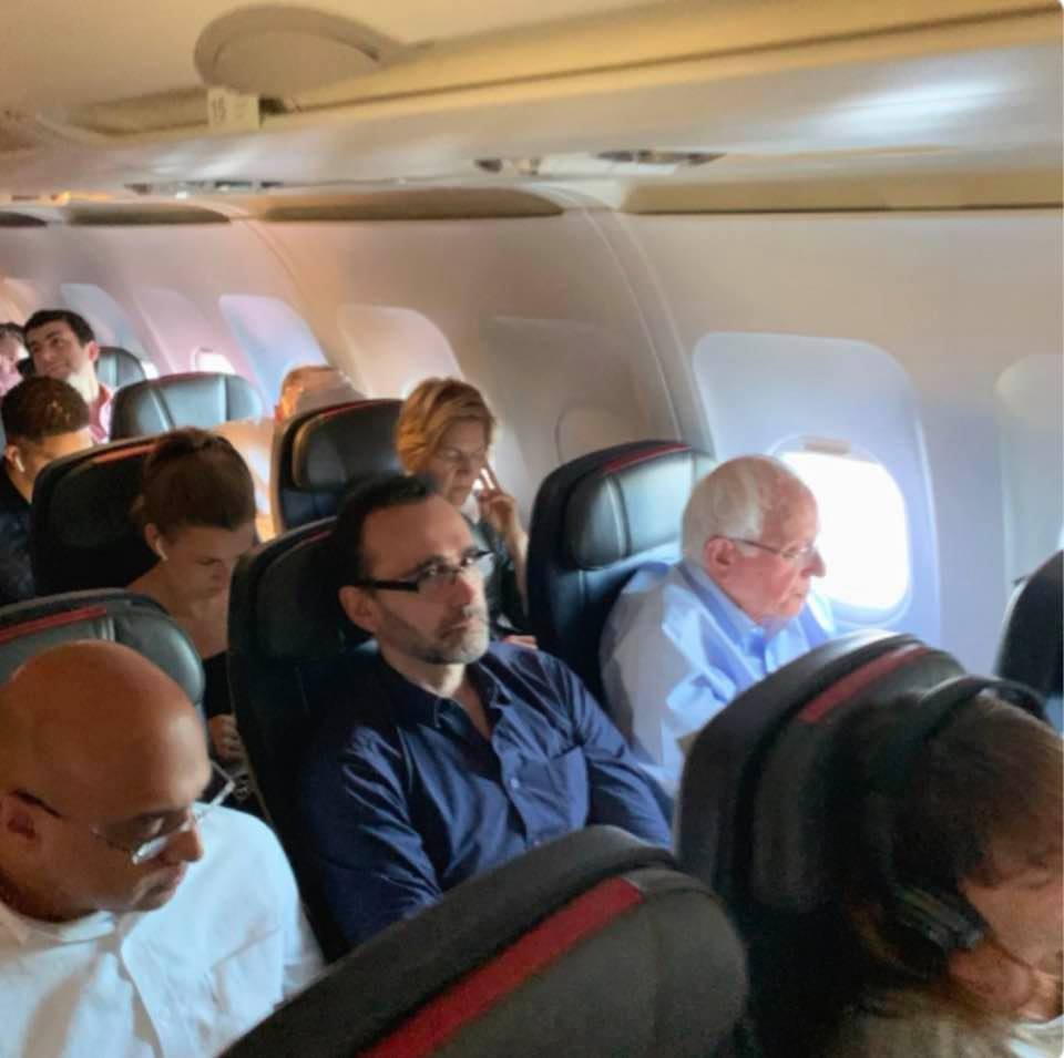 Photo of Bernie Sanders and Elizabeth Warren on a flight to Miami