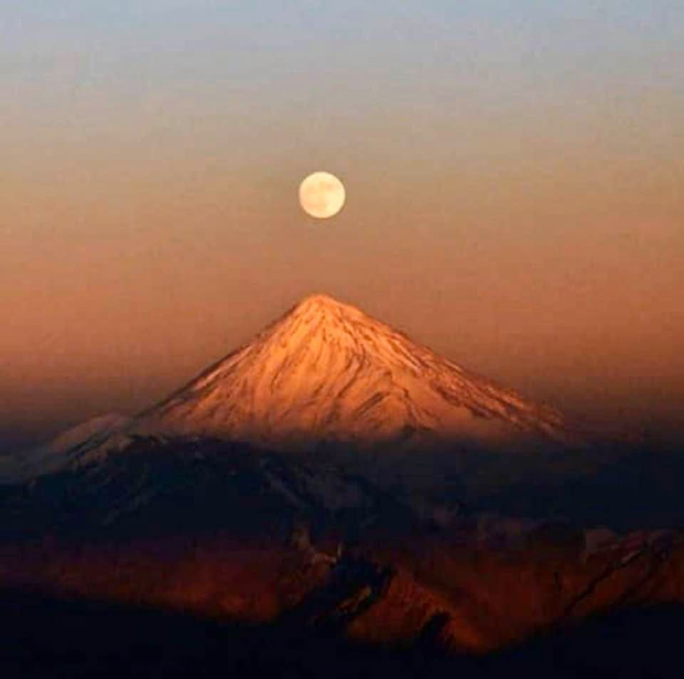 Full moon over a snow-covered Mount Damavand, Iran