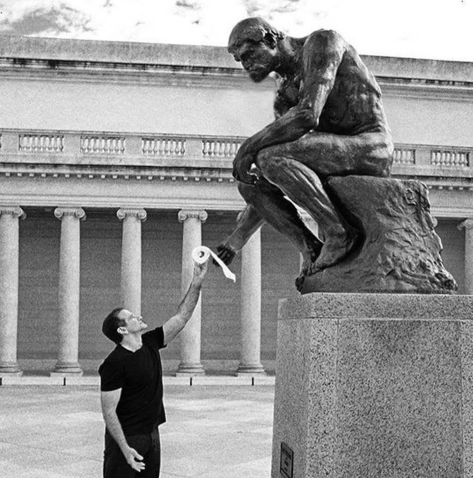 Genius comic Robin Williams handing a roll of toilet paper to 'The Thinker' statue