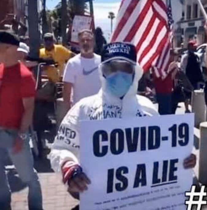 This guy thinks COVID-19 is a lie, but, judging by his protective gear, he isn't absolutely sure!
