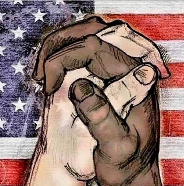 Black hand holding white hand, with US flag in the background