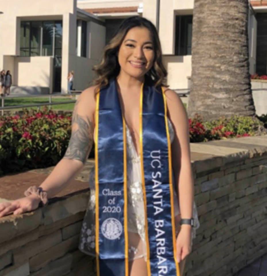 A UCSB 2020 woman graduate on a campus photo shoot