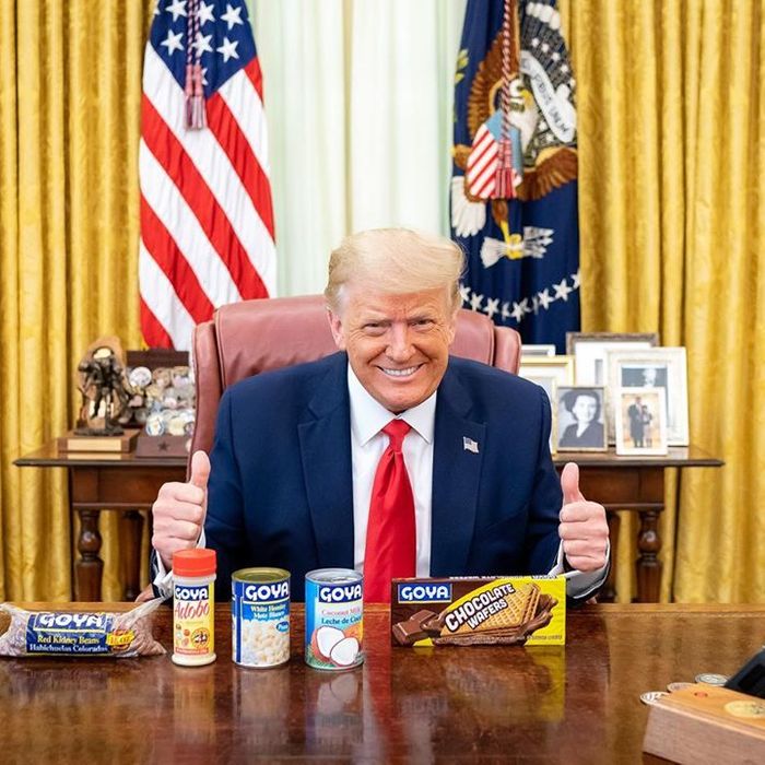 President is all smiles while posing with cans of beans and other food products in the Oval Office!