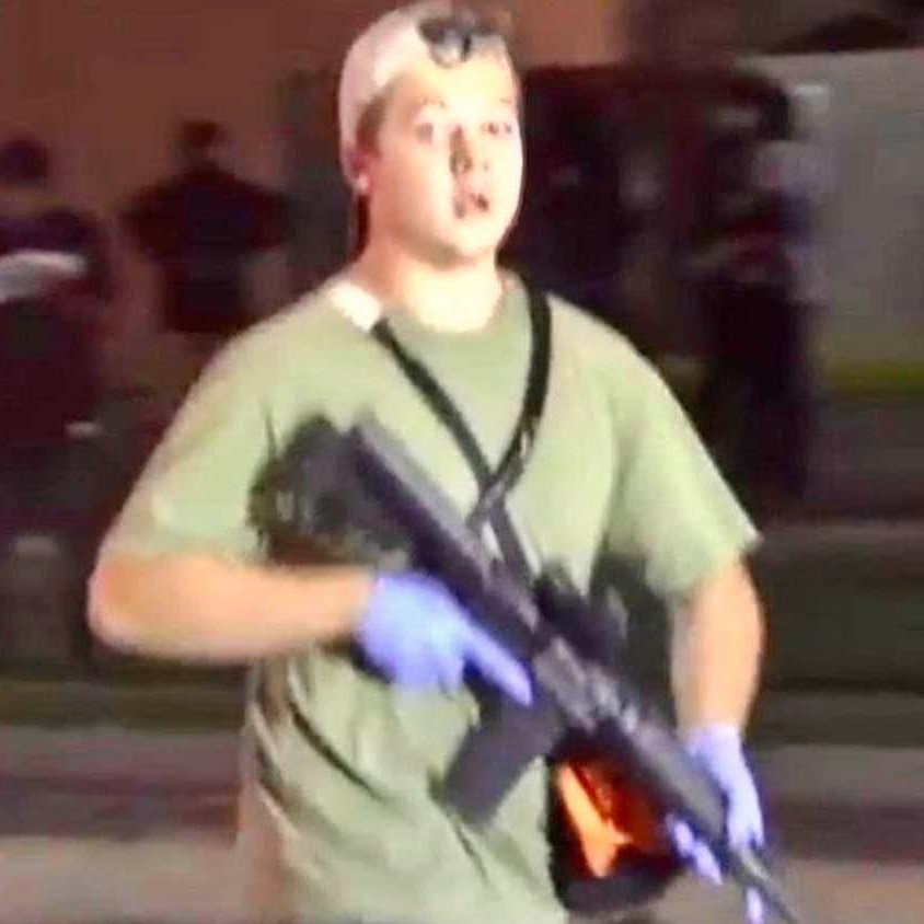 Underage young man carrying a military-grade assault rifle