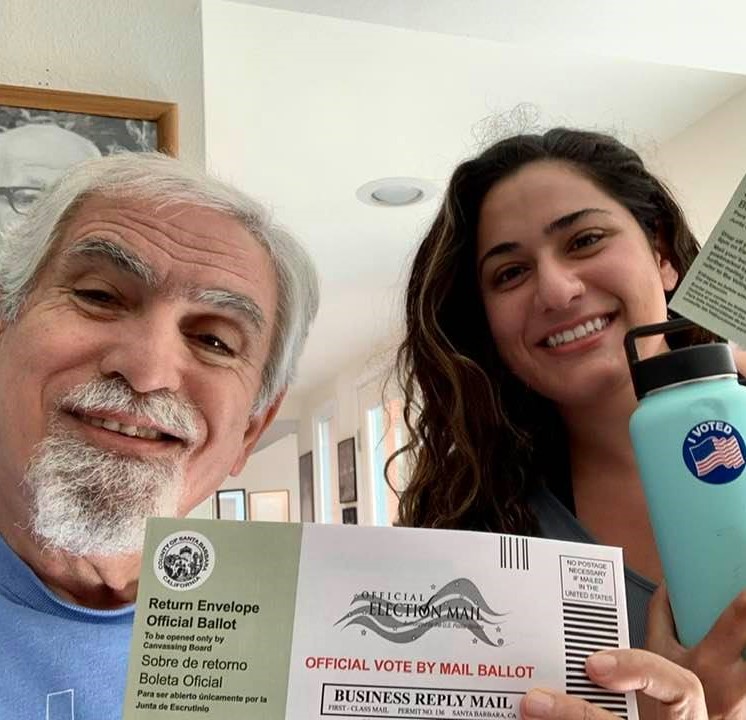 My daughter and I, with our ballot envelopes and 'I Voted' stickers