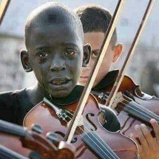 Diego Frazzo Turkato, 12, weeps at his music teacher's funeral, playing a favorite song that saved him from poverty and despair