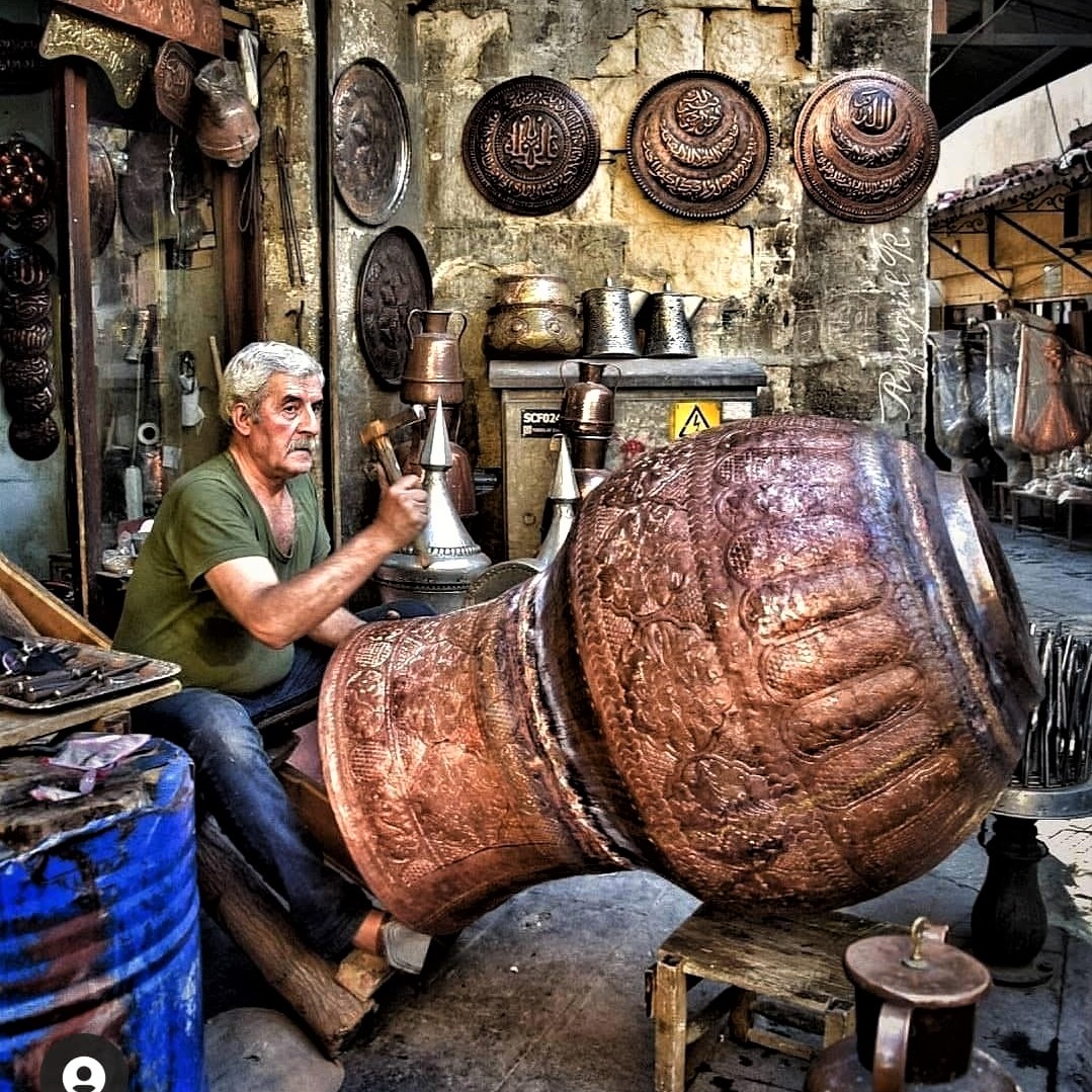 Artist at work in Esfahan's copper market, built in Iran's Safavid era, some 400 years ago