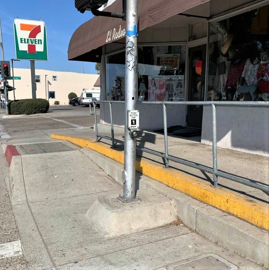 Split-level sidewalk in Old Town Goleta, with levels abruptly ending or merging in places, and obstacles presenting hazards even for sighted pedestrians