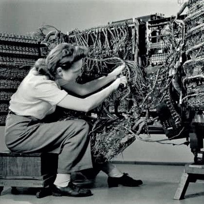 Woman shown wiring a pre-computer-era IBM 405 giant accounting machine in 1934