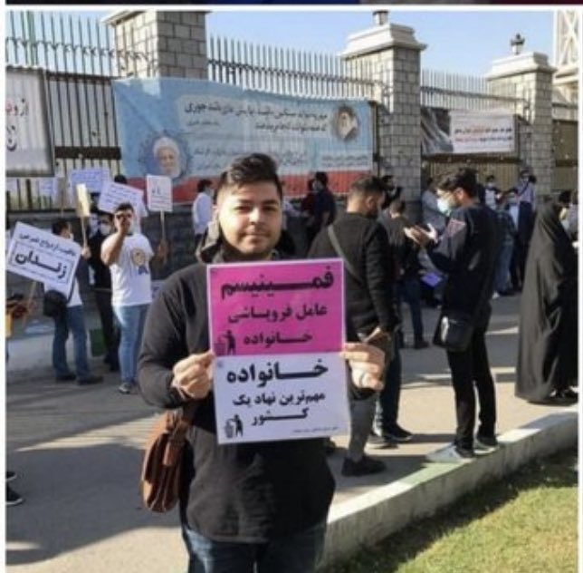 Anti-women protesters in Iran carry signs that hold feminism responsible for the country's social ills