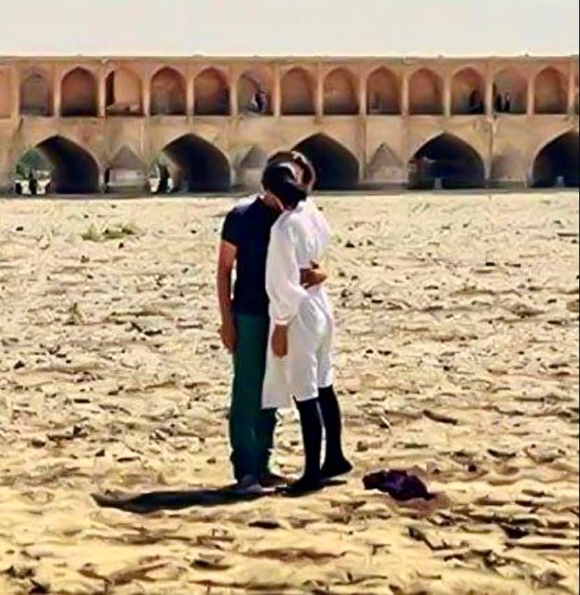 Young couple kissing on the dried-up bed of Zayandeh-Rood in Isfahan, Iran