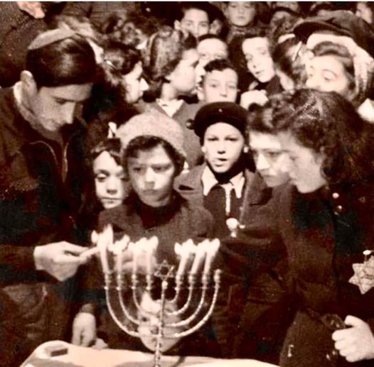 Jewish families celebrating the seventh night of Hanukkah during World War II (1943) in Netherlands